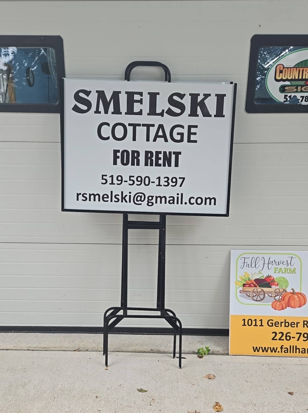 Smelski Cottage rental sign on a freestanding frame