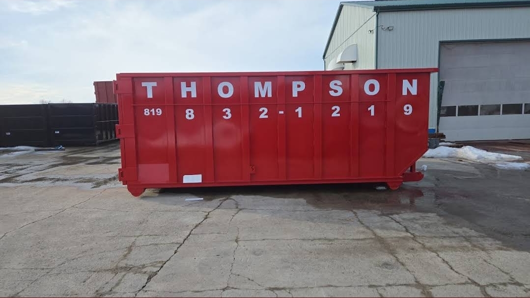 White Thompson lettering on a red commercial container